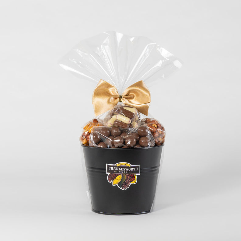 Gift Basket filled with Beer Nuts, Chocolate Apricots, Bullet Bonanza, Spicy Crackers wrapped in cellophane with a gold bow.