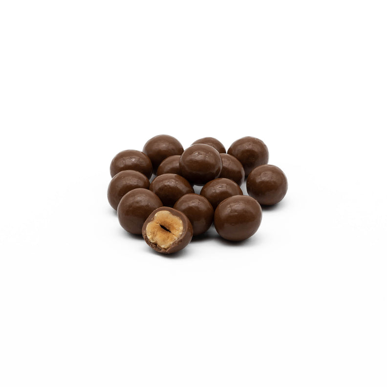 Blanched hazels, coated in layers of milk chocolate
