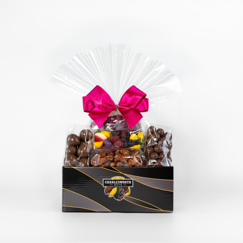 Mother's Day gift basket filled with macadamias, almonds, chocolates and lollies. Perfectly wrapped with a pink bow. 