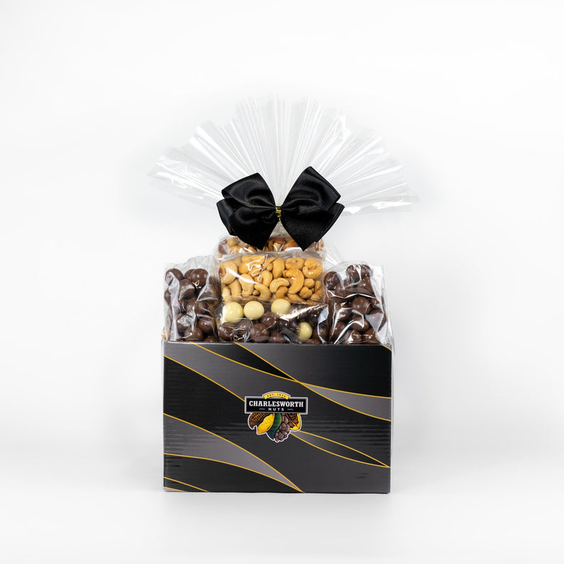 Gift Basket with orange ribbon filled with beer nuts, chocolate bullets, salted cashews, crackers and more.