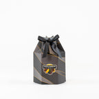 "Gift box with a black ribbon filled with nuts and chocolates"