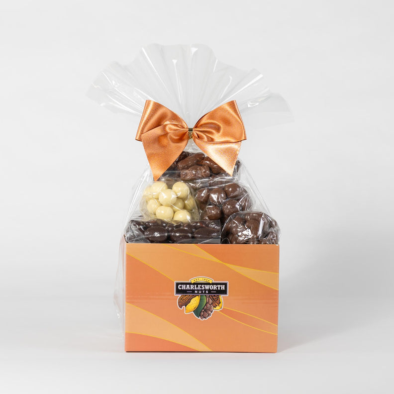 Gift basket filled with delicious white, dark and milk chocolate wrapped in cellophane and tie with a orange bow. 