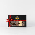 "Christmas gift box filled with dark, white and milk chocolates."