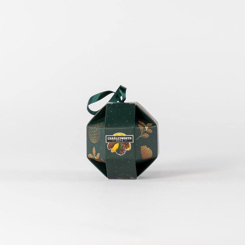 Christmas green gift box shaped like a Christmas bauble, filled with festive treats.