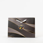 "Corporate gift bag filled with beer nuts, chocolate bullets, licorice, nut mix, and dried apricots." 