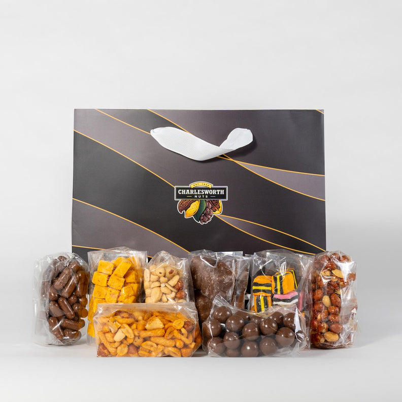 Gift bag filled with 8 individually wrapped  Charlesworth Products including beer nuts, spricot fruit pieces, chocolate apricots, chocolate honey comb, licorice allsorts and more