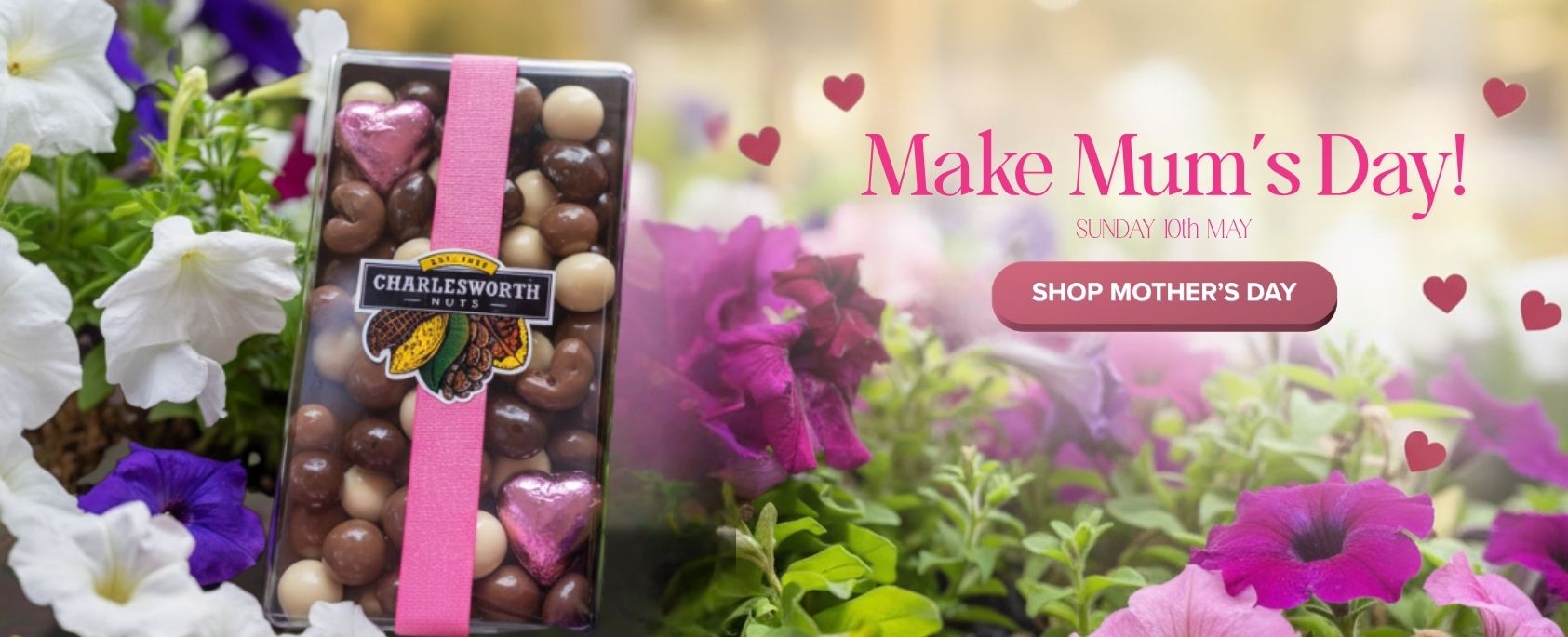 "Chocolate box with pink ribbon surrounded by flowers and Mother's Day promotional text."