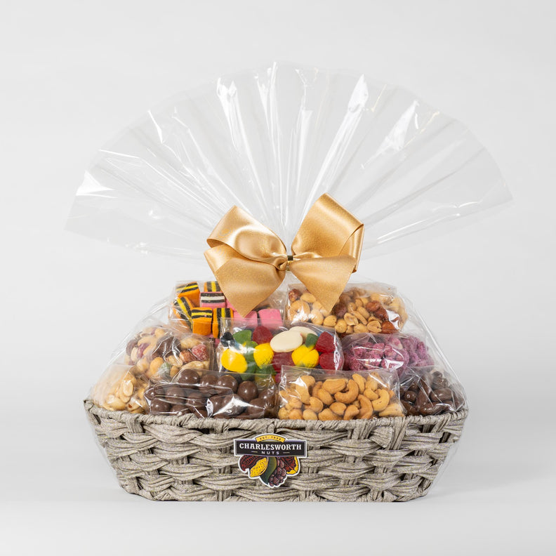 gift basket containing 17 exquisitely wrapped Charlesworth Nuts and assorted chocolates, carefully arranged in a reusable woven basket.
