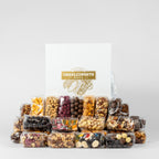 "Luxury white corporate gift box filled with nuts, chocolates, and lollies." 