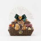 "Christmas hamper filled with nuts, chocolates and lollies, adorned with a green Christmas bow" 