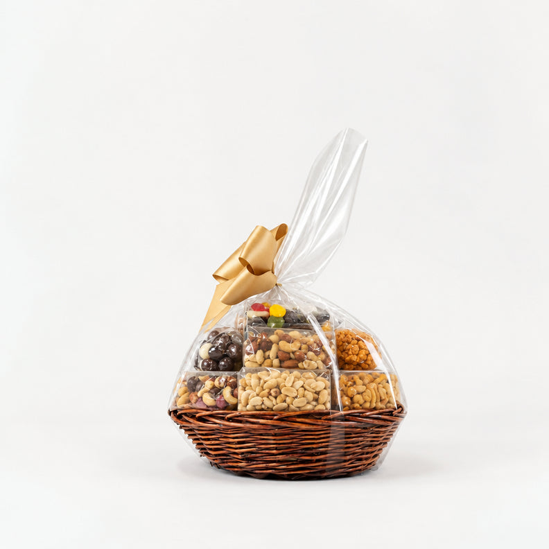 A wicker basket filled with assorted snacks and treats, wrapped in clear cellophane and tied with a gold bow.