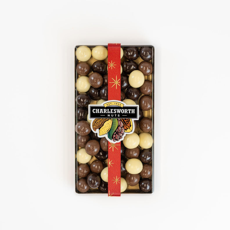 Christmas gift box filled with a red ribbon and filled with white, dark and milk chocolates.